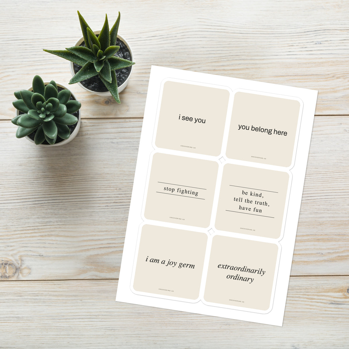 Six phrases sticker sheet, shown on a desk